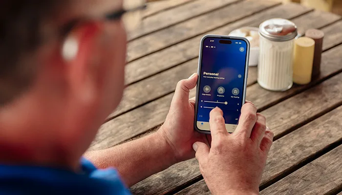 Person connecting Hearing Aids to app