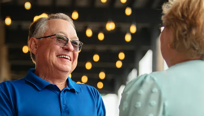 Man wearing Hearing Aid hearing partner speak